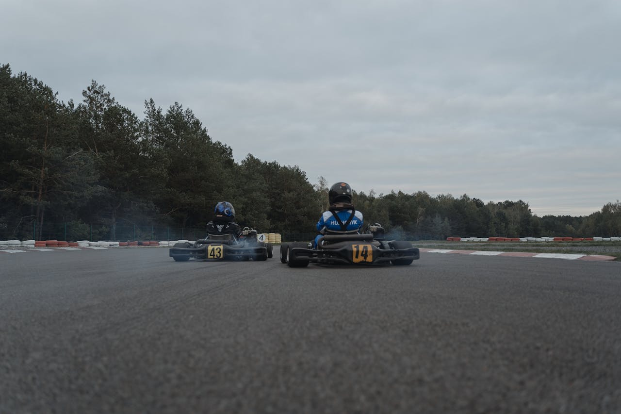Intense go-kart racing with two drivers speeding around a winding track at high speed.