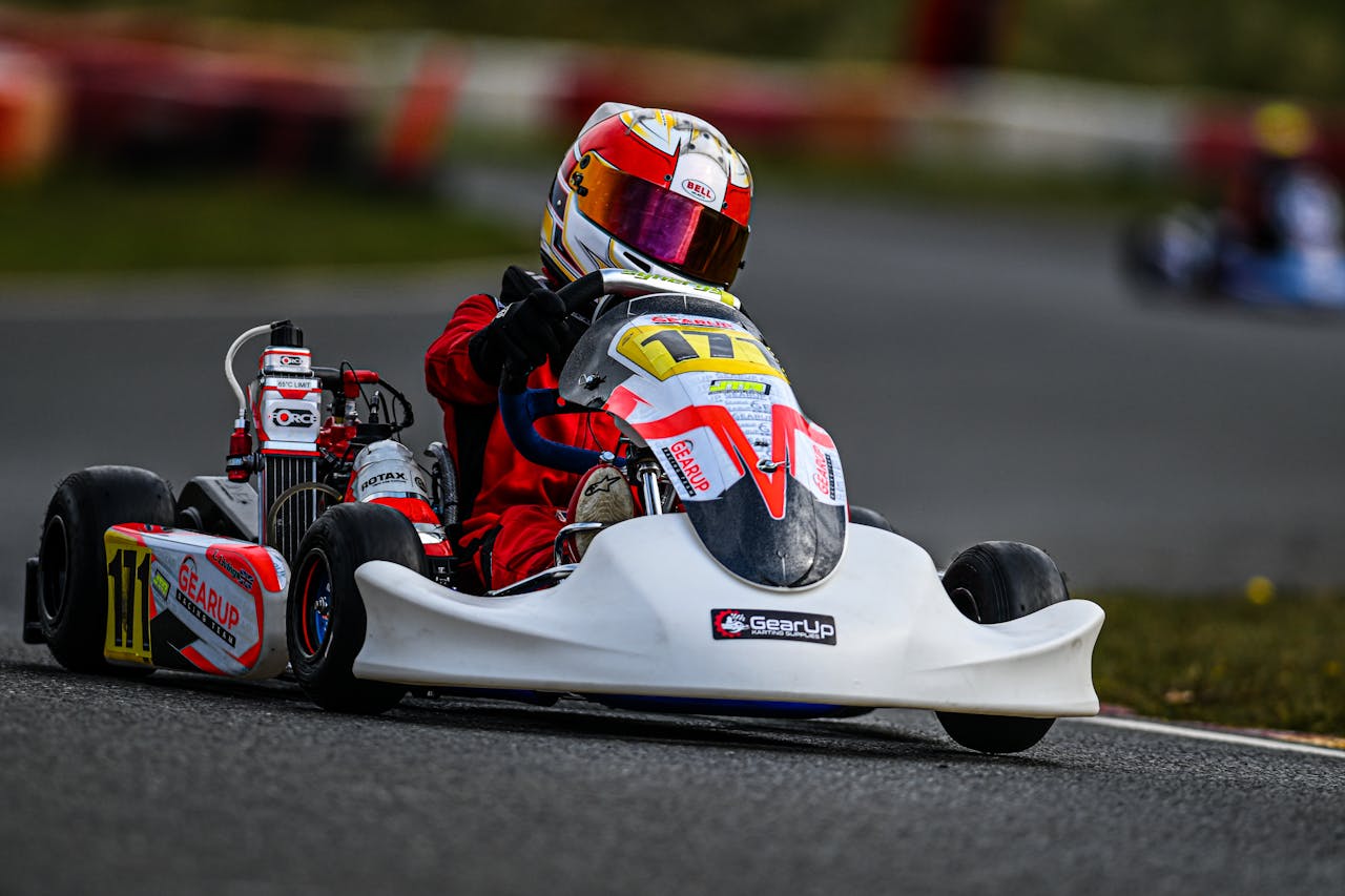 A thrilling go-kart race with driver navigating the circuit track at high speed.